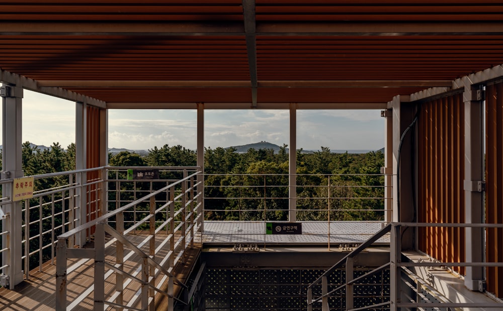 a balcony with a view of a forest
