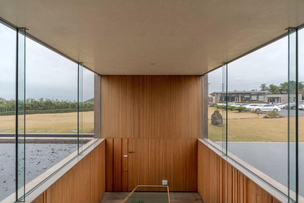 a room with glass walls and a wooden wall