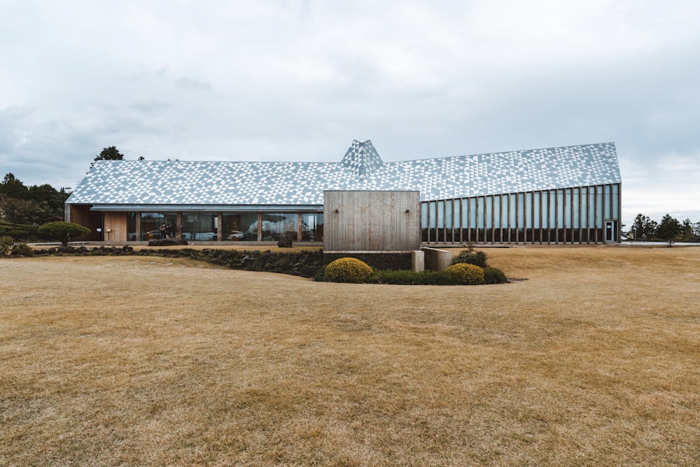 a house with a blue tiled roof and a lawn