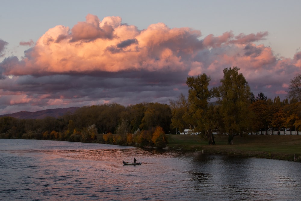 a couple of people in a boat on a lake