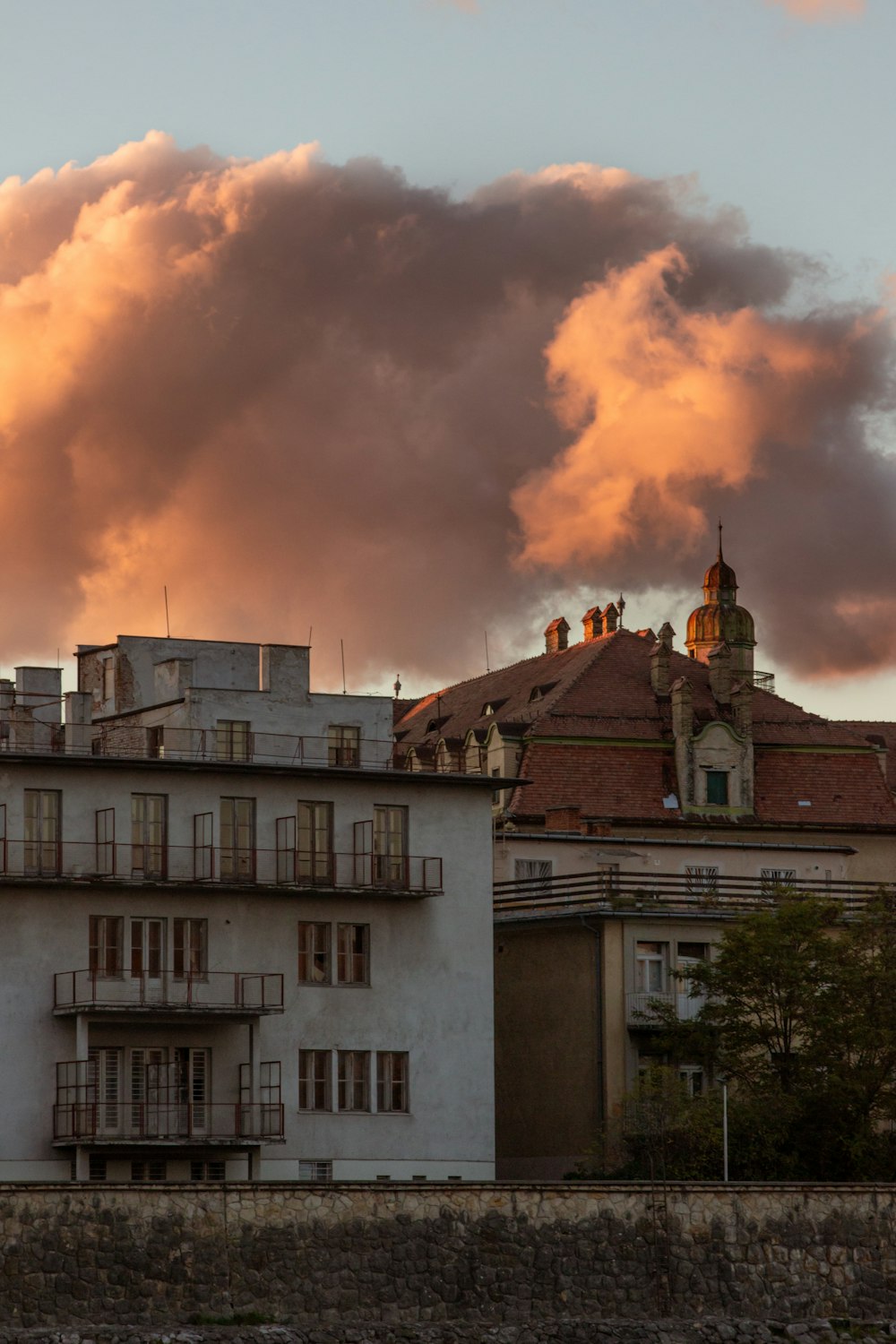 a building with a lot of windows in front of a cloudy sky