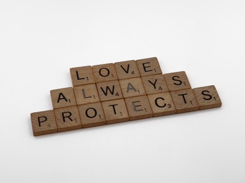 scrabble tiles spelling love, always, protect, and protect