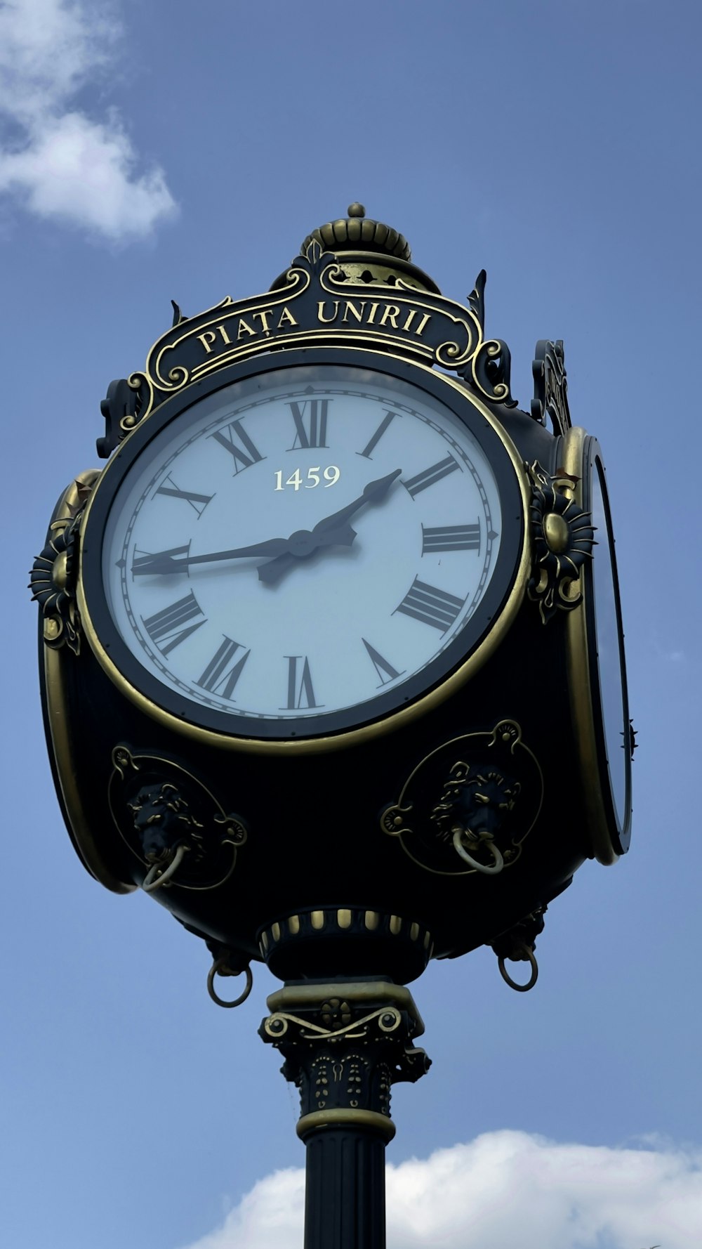 a black and gold clock with roman numerals