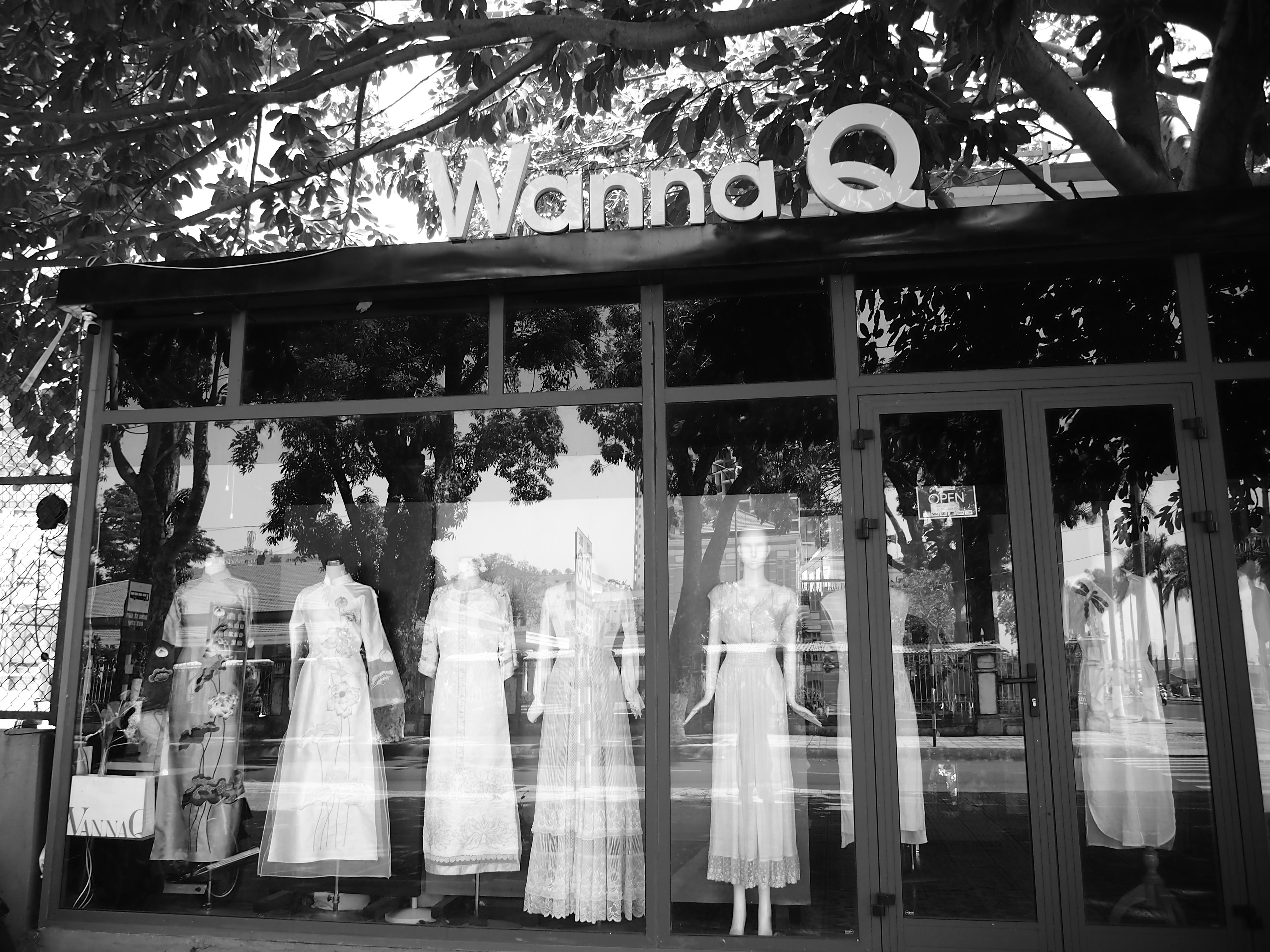 a store front with mannequins in the window