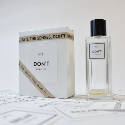 A minimalist perfume bottle with a crisp white label, set against a light, airy backdrop.