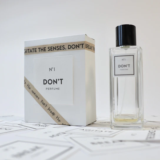 A minimalist display of di·niente's elegant perfume bottles.