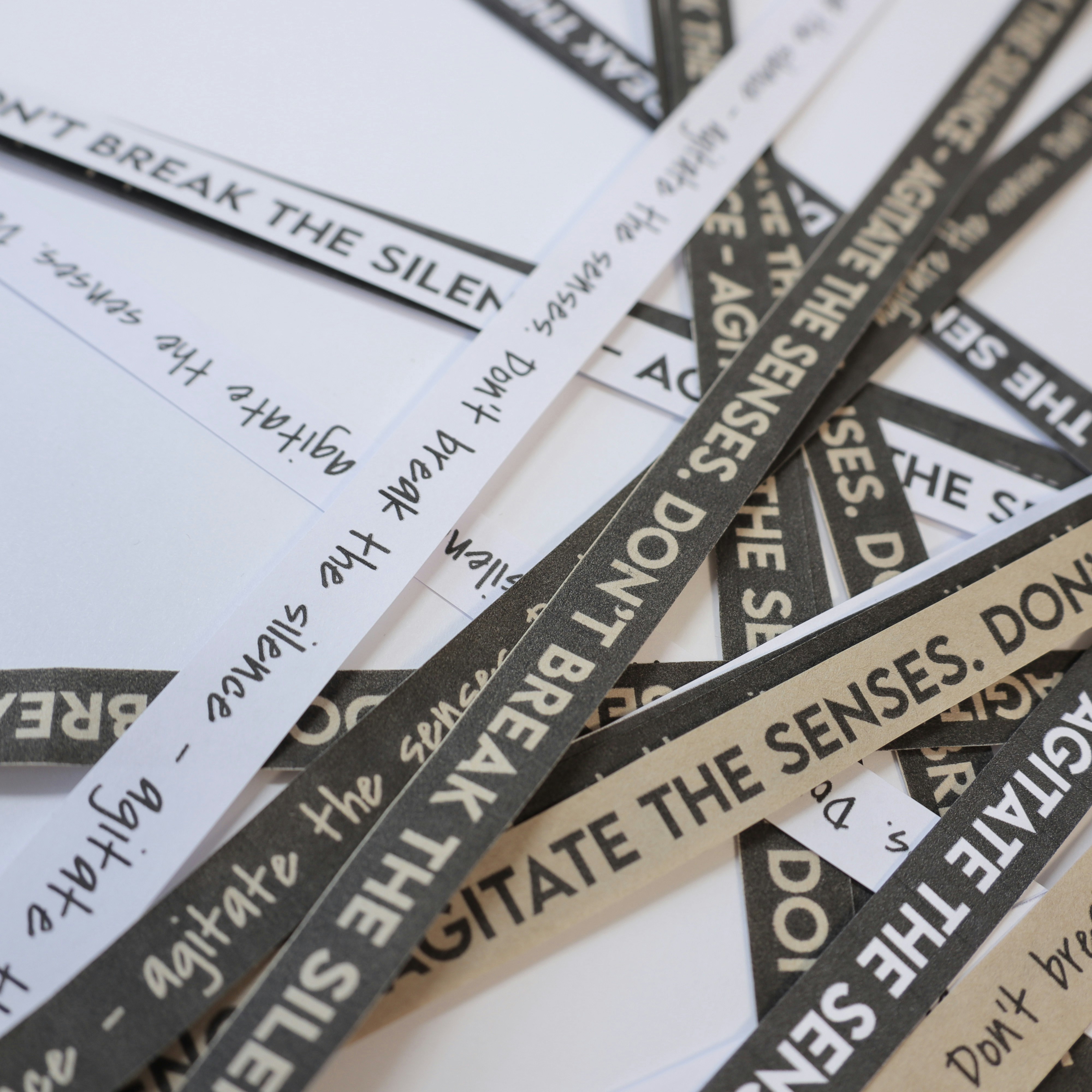 a pile of black and white signs sitting on top of each other