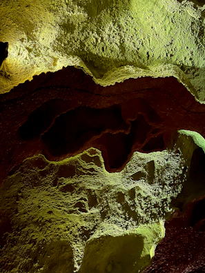 3D terrain model illuminated with subtle green and aqua accents.