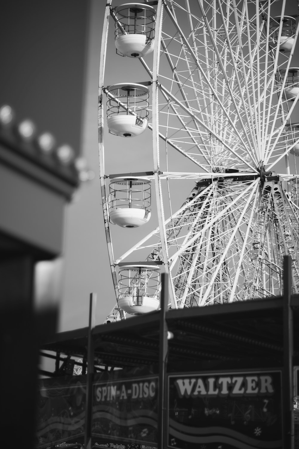 a black and white photo of a ferris wheel