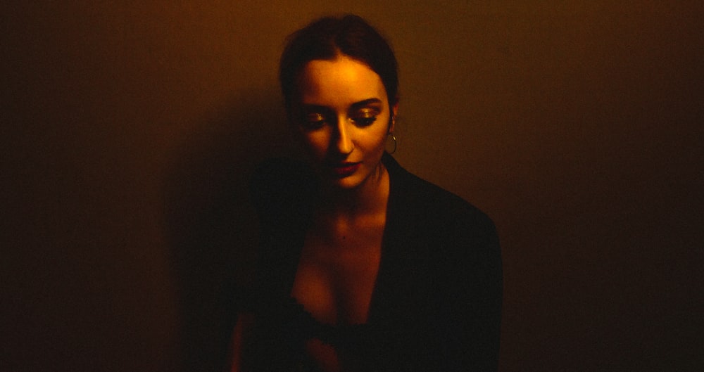 a woman in a dark room posing for a picture