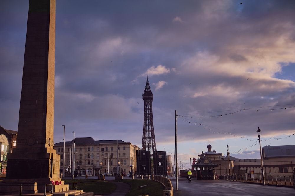 a street with a tall tower in the background