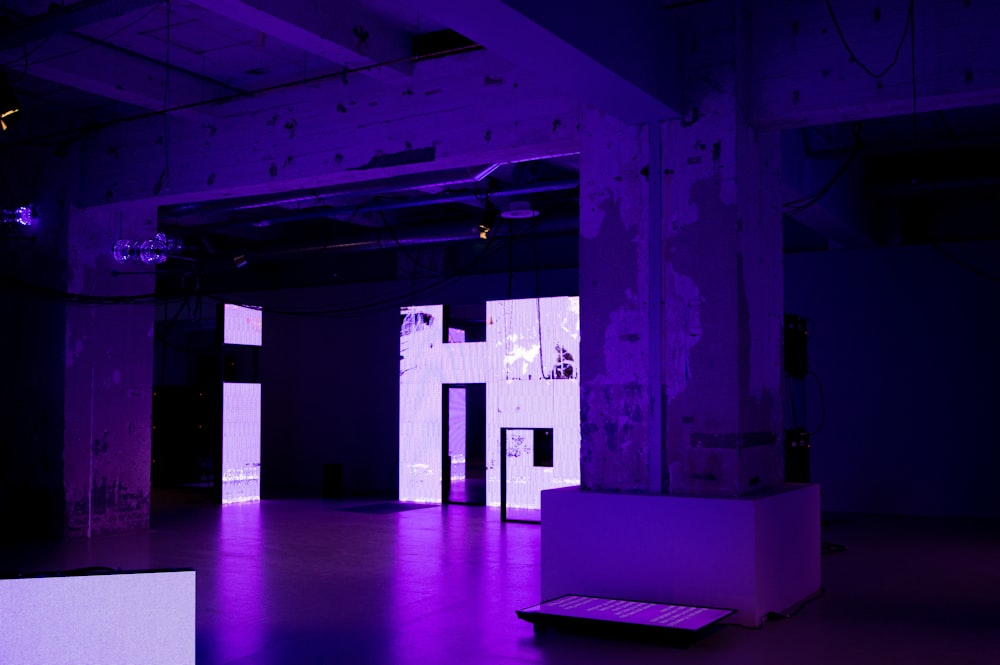 an empty room with a purple light in it