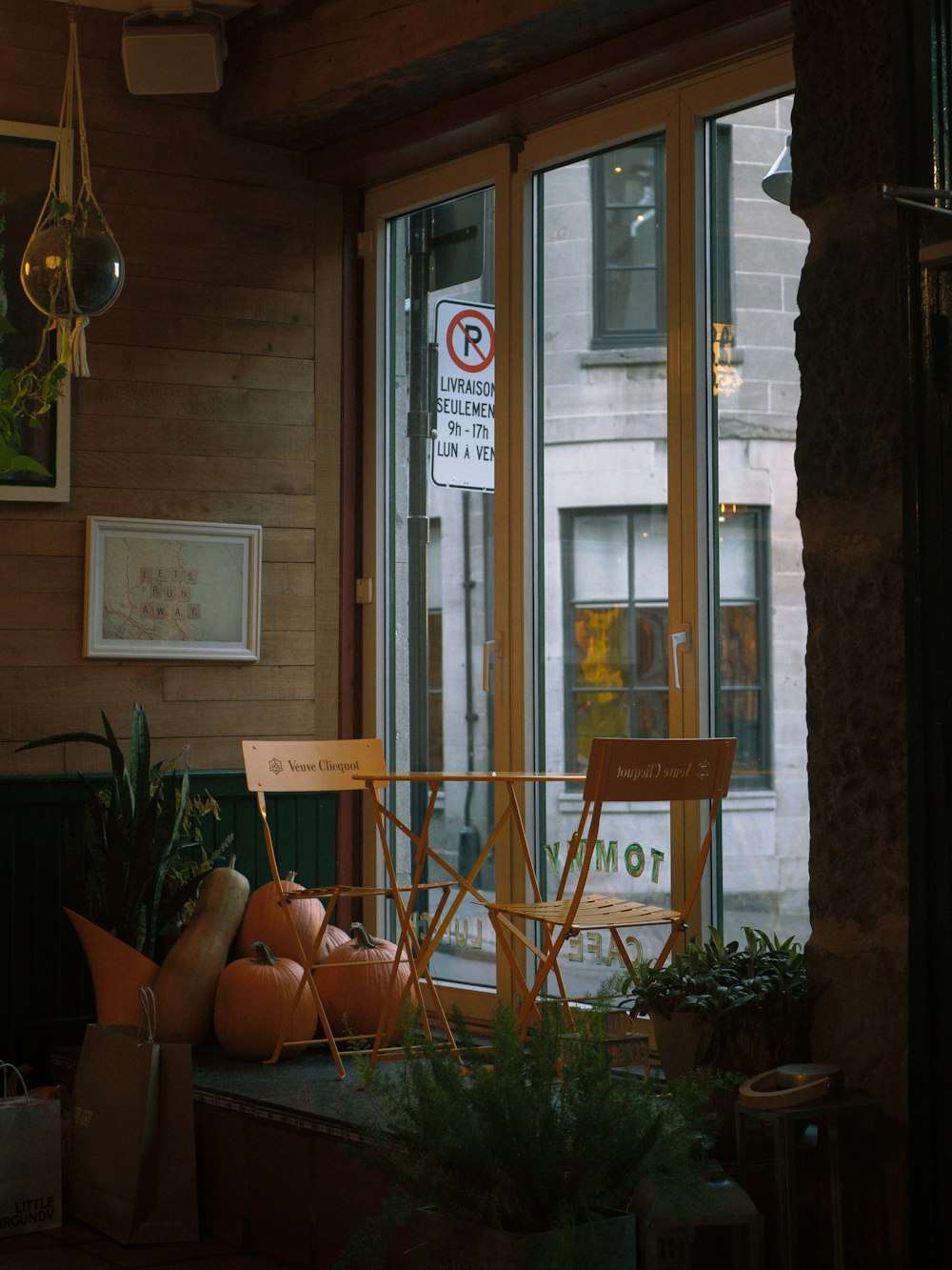 a room with a chair and a sign in the window