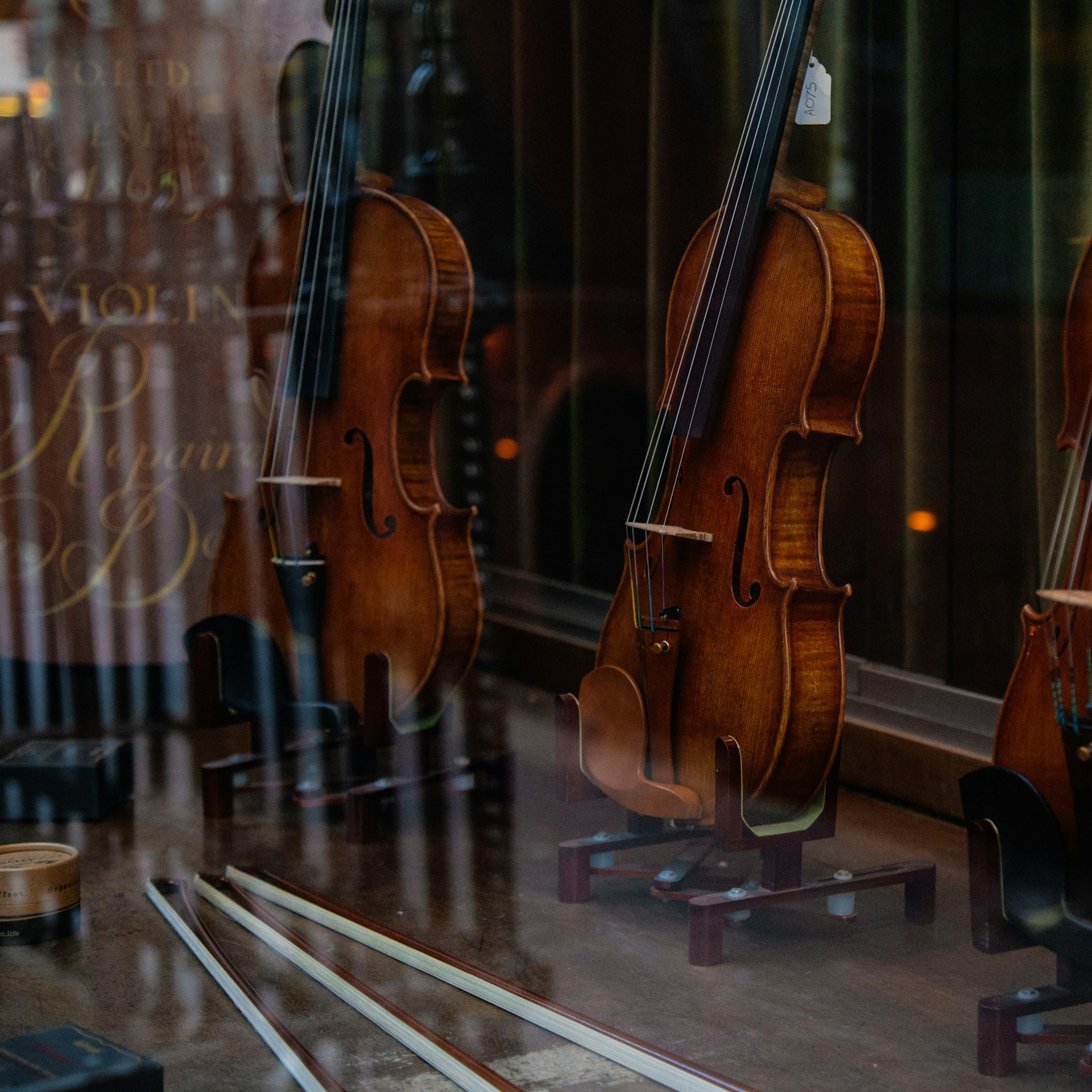 a group of violin's sitting in a window