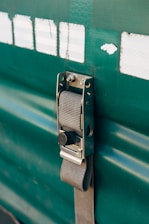 a close up of a door handle on a green door