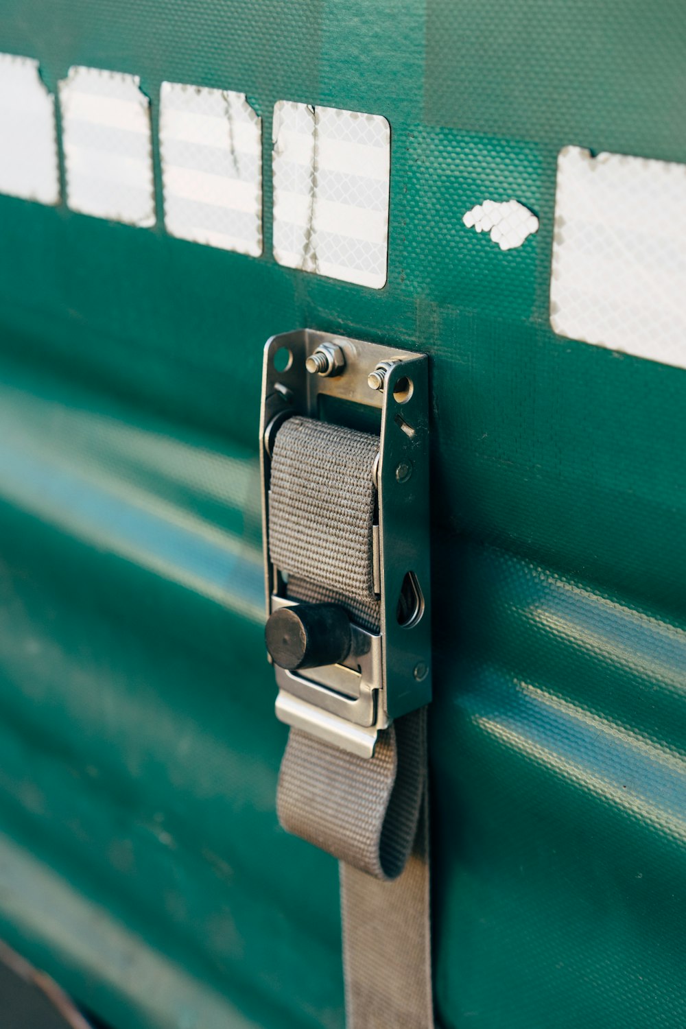 a close up of a door handle on a green door