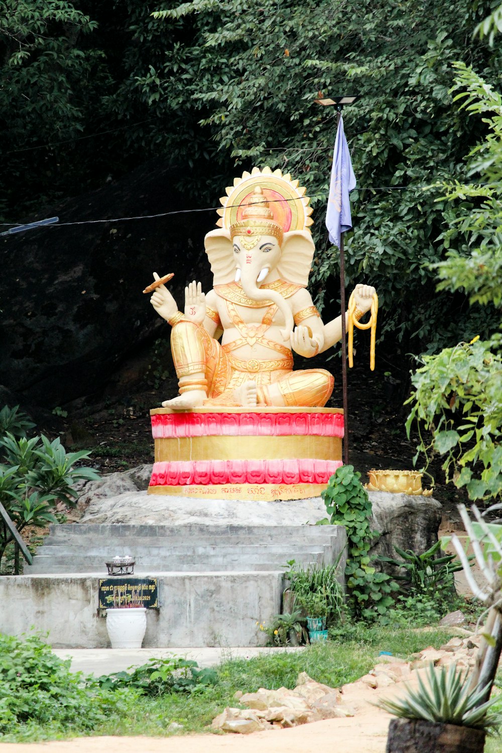 a statue of an elephant in a garden