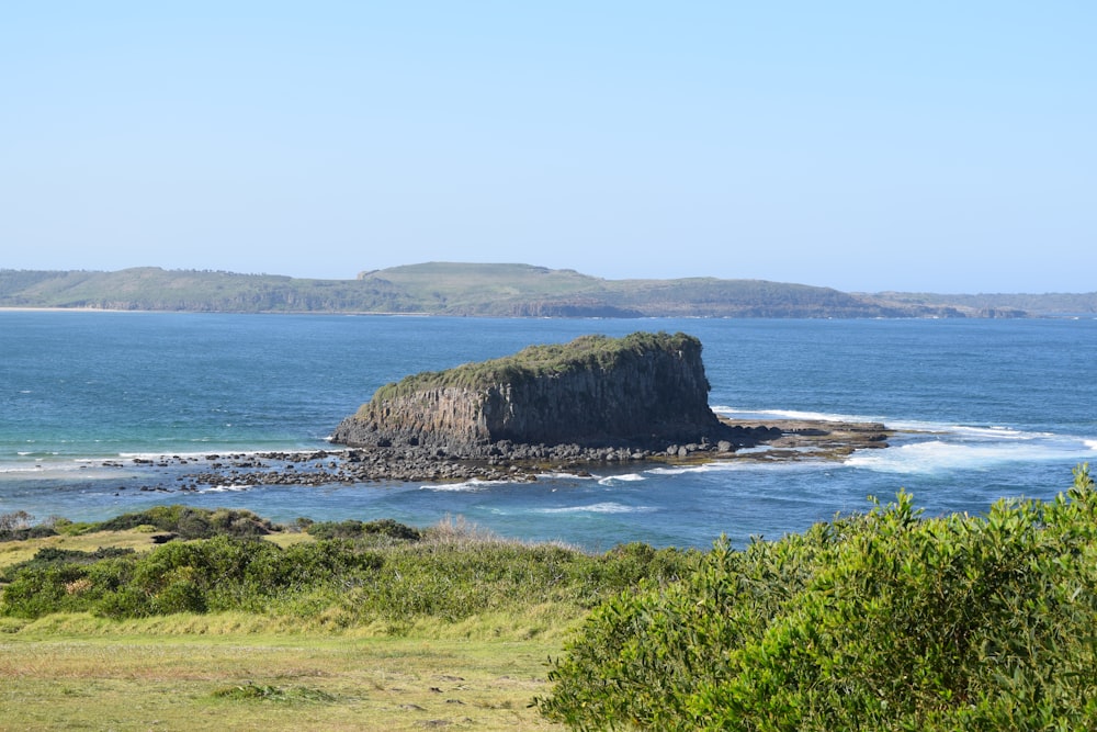 a large rock out in the middle of the ocean