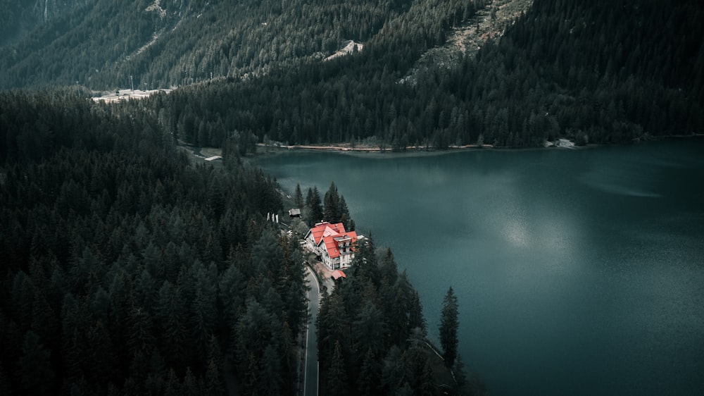 an aerial view of a house in the middle of a forest