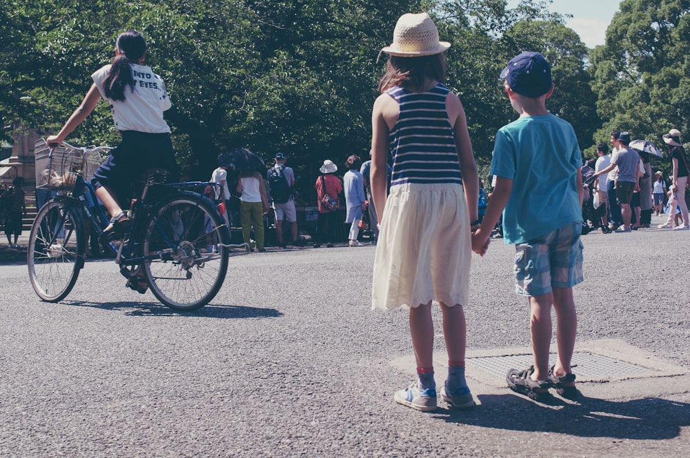 a group of people standing on the side of a road