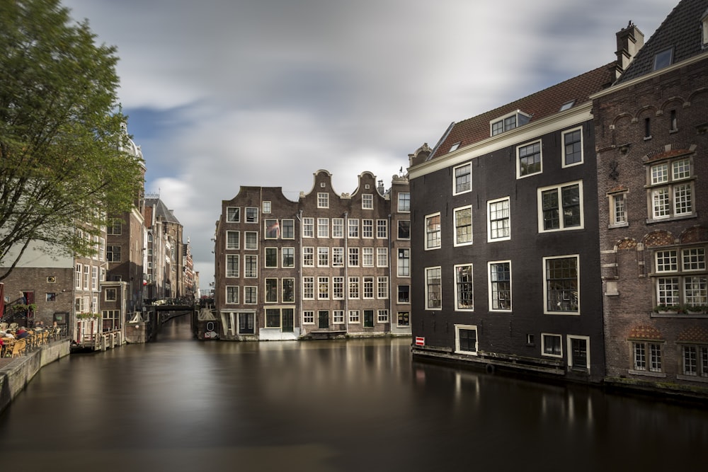 a river running through a city next to tall buildings