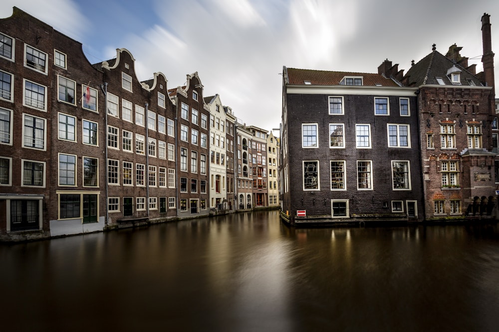 a row of buildings next to a body of water