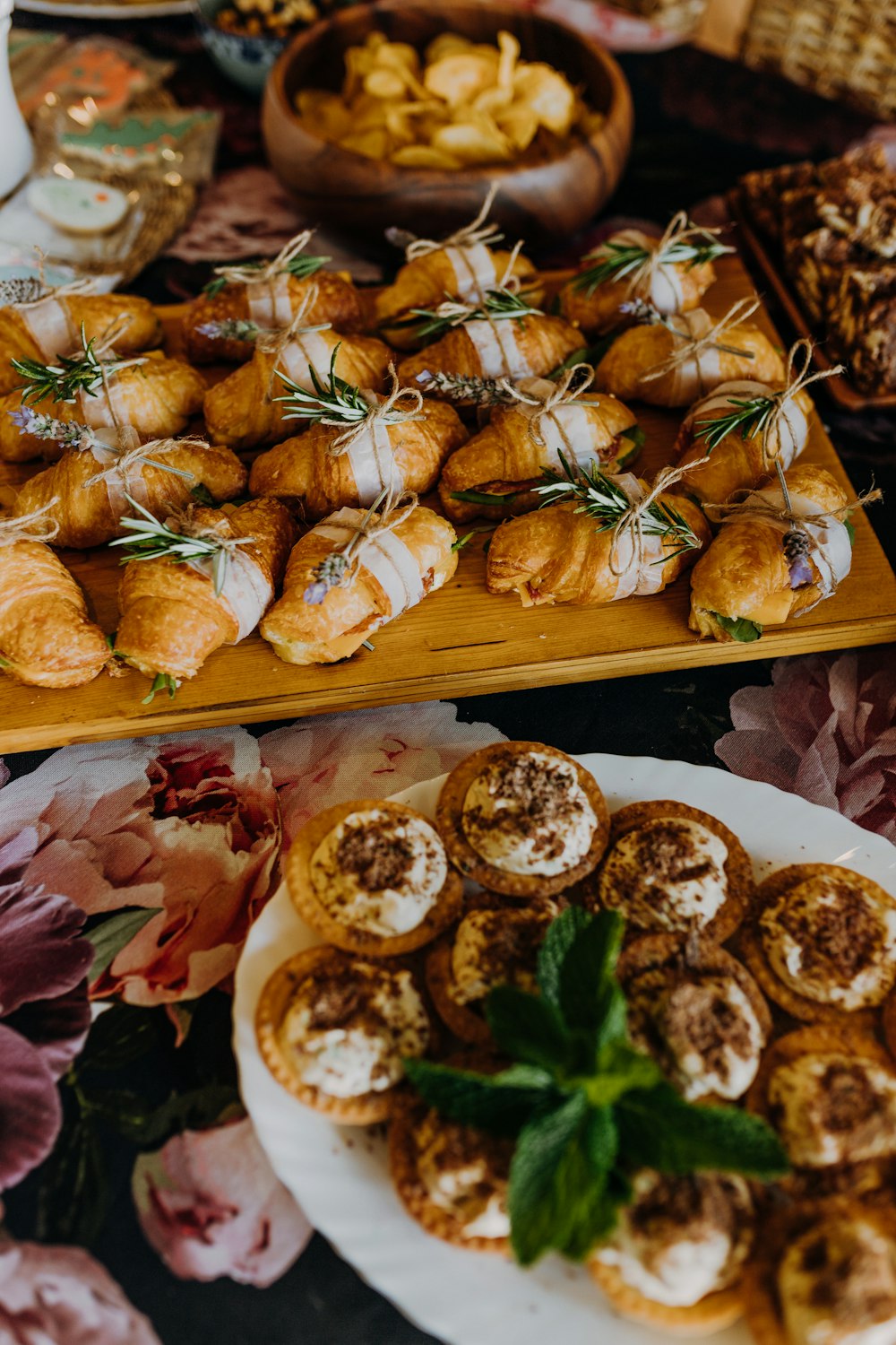 a table topped with plates of food next to a tray of food