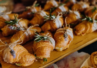 a wooden table topped with lots of pastries