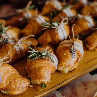 a wooden table topped with lots of pastries