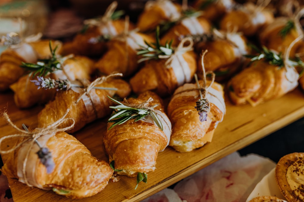 a wooden table topped with lots of pastries