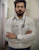 a man with a stethoscope standing with his arms crossed