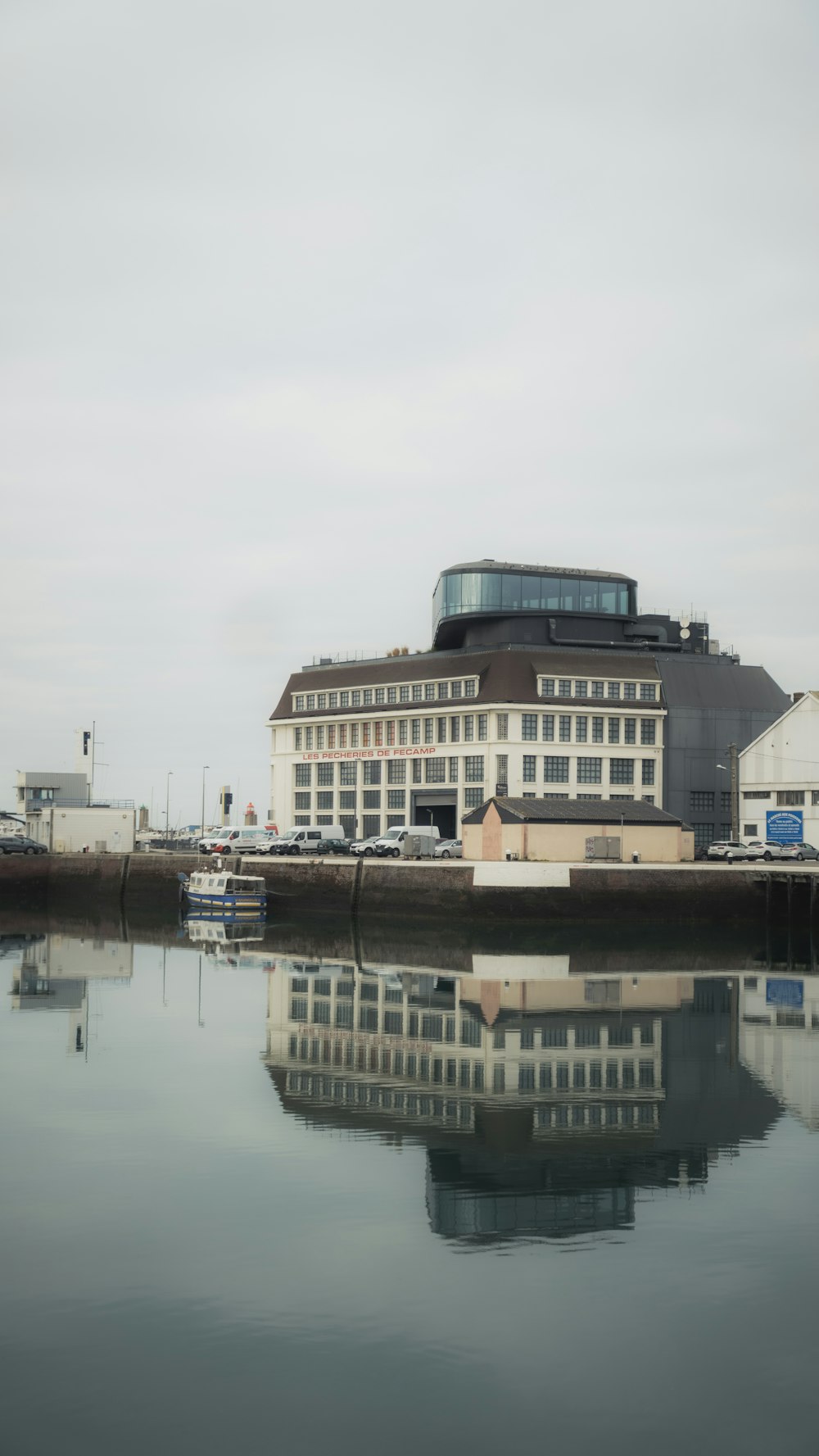 a large building sitting next to a body of water