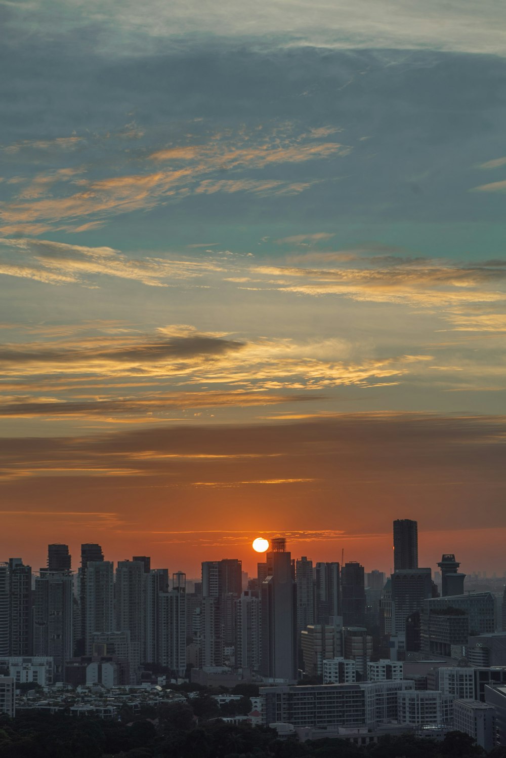 the sun is setting over the city skyline