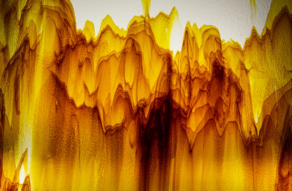 an abstract painting of yellow and brown colors