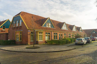 a row of houses with cars parked in front of them