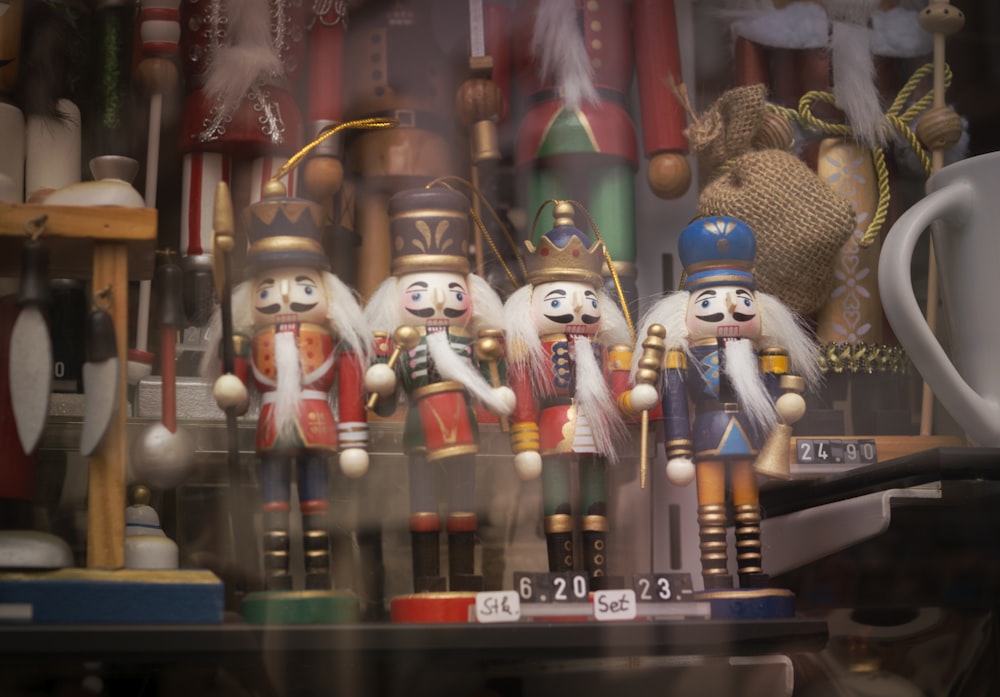 a group of nutcrackers sitting on top of a shelf