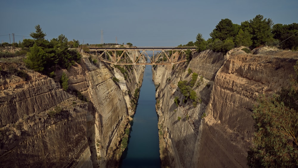 a bridge over a river in a canyon