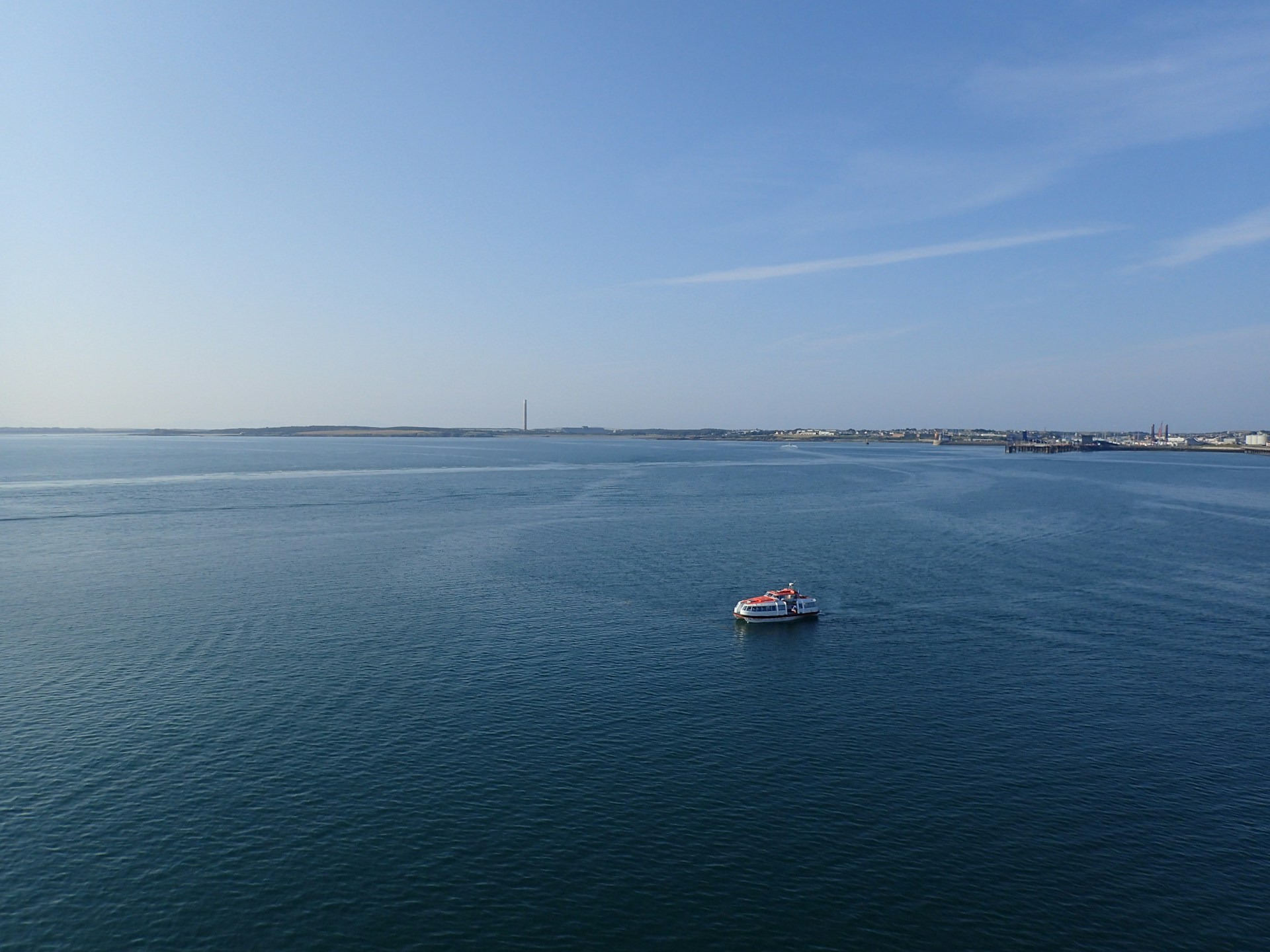 a small boat in the middle of a large body of water