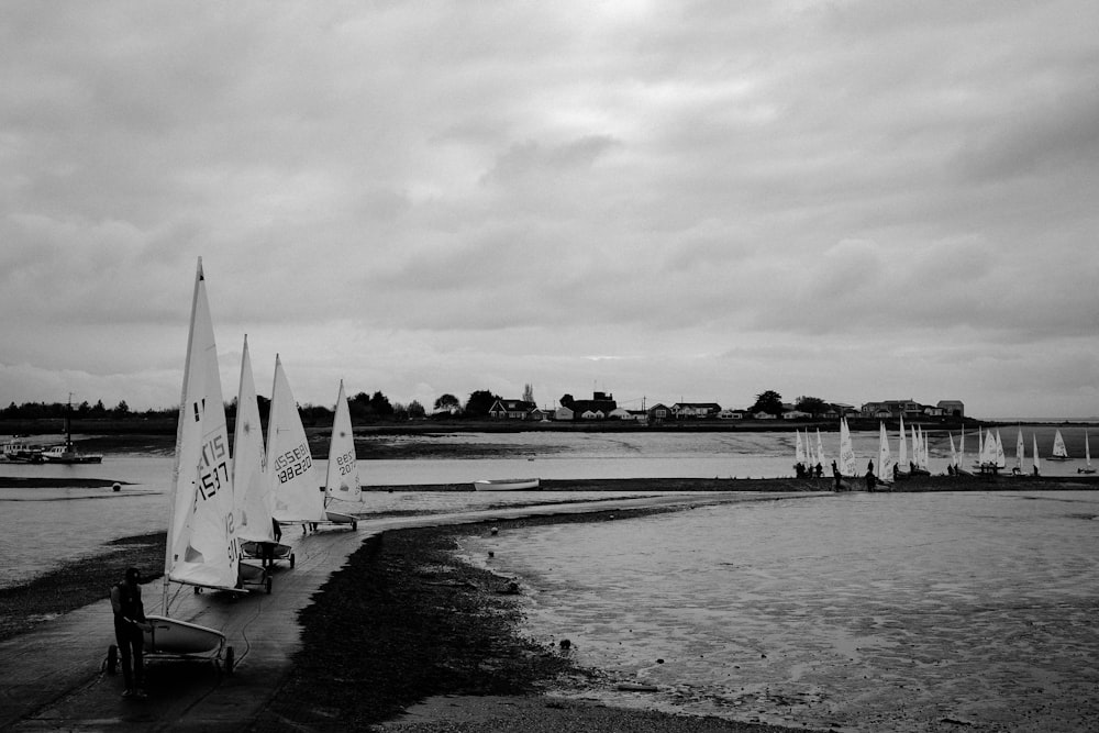 a group of sailboats sitting on top of a beach