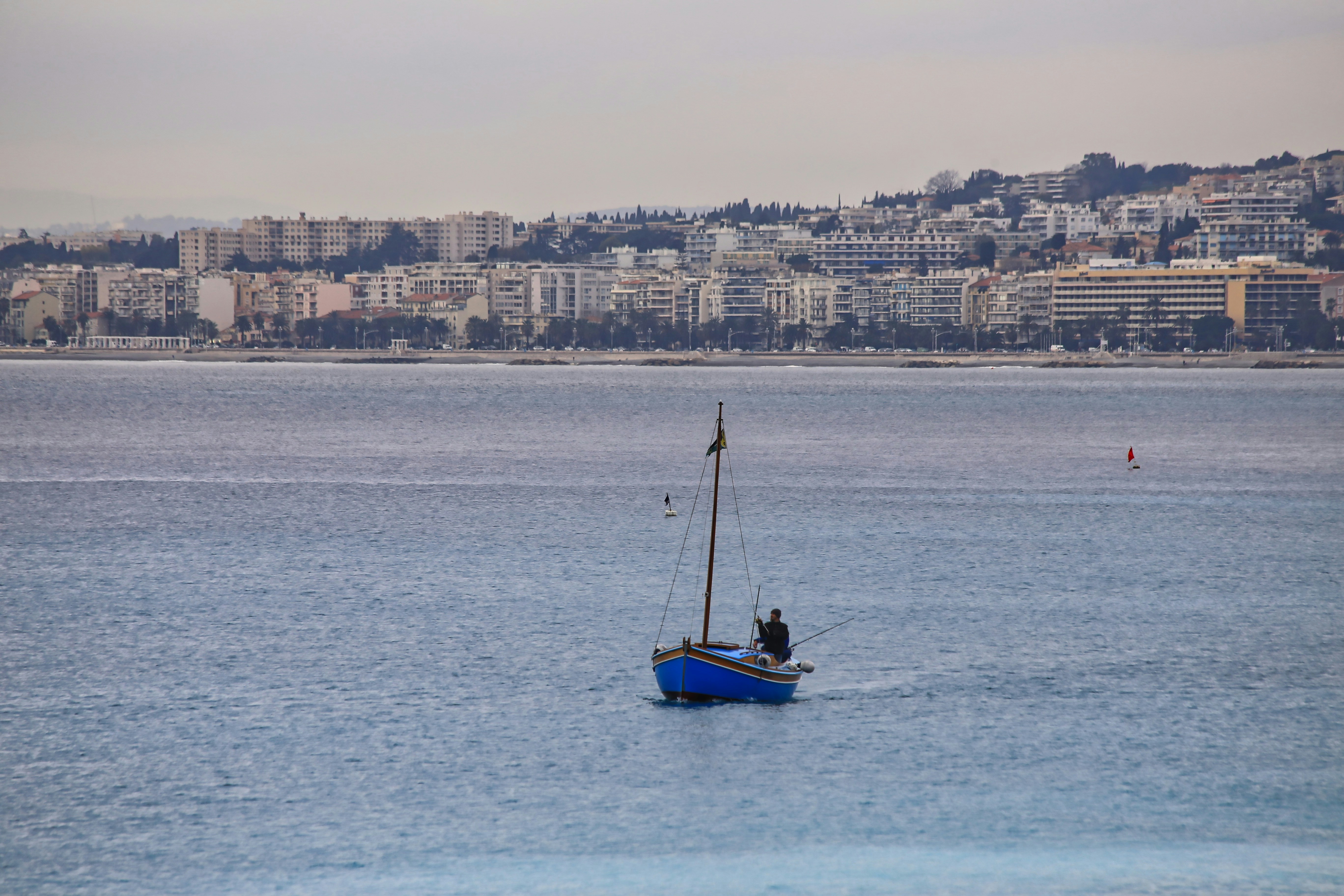 a small boat in the middle of a large body of water