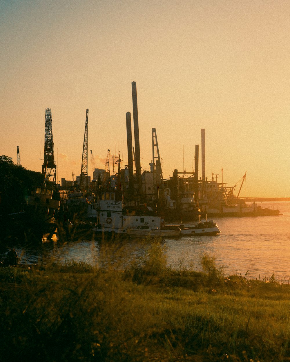 a harbor filled with lots of boats at sunset