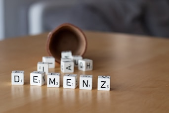 a wooden table topped with dices and letters