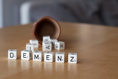 a wooden table topped with dices and letters