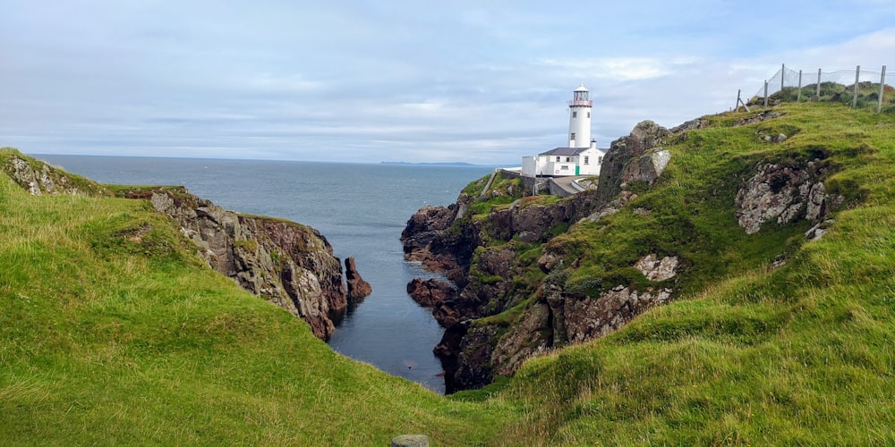 a lighthouse on a cliff overlooking a body of water