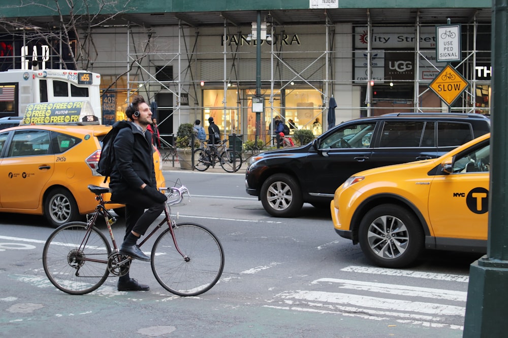 a man riding a bike on a city street