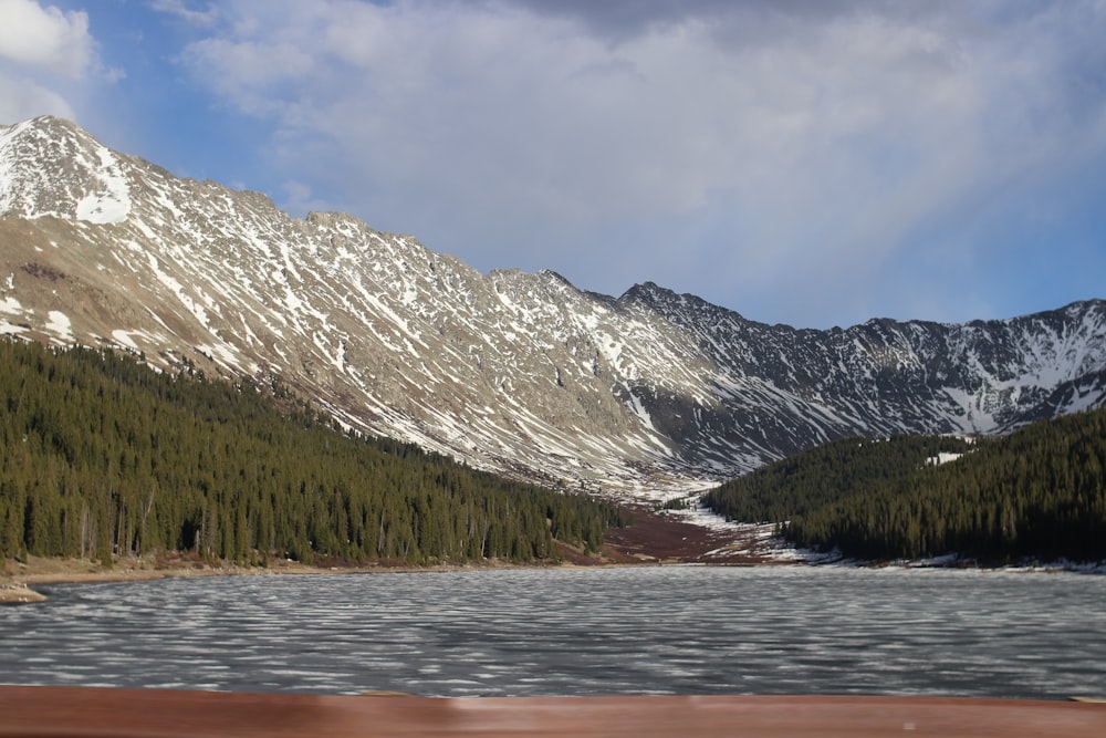 a view of a snow covered mountain and a lake