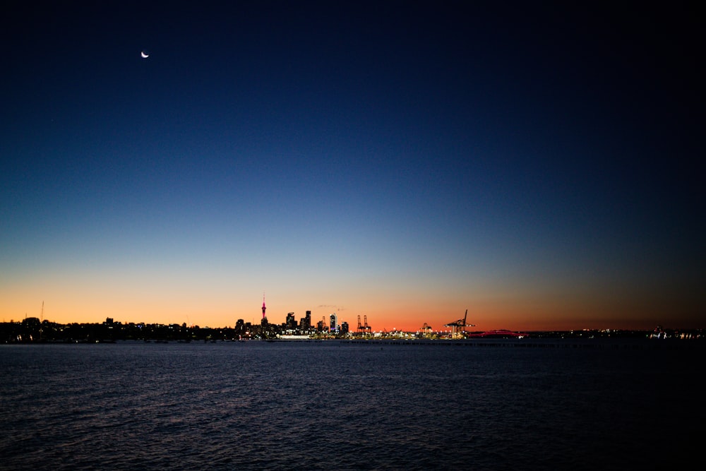 a large body of water with a city in the background