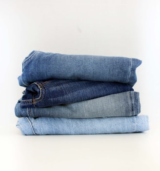 a stack of jeans sitting on top of each other