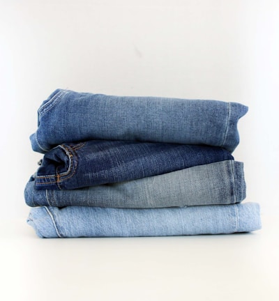 a stack of jeans sitting on top of each other