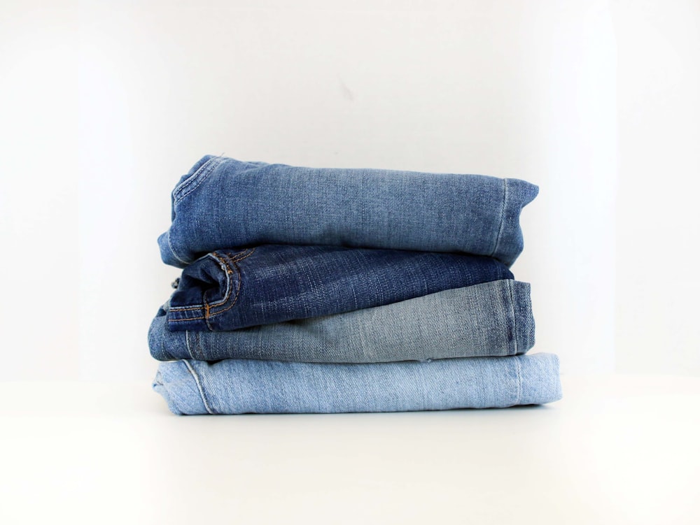 a stack of jeans sitting on top of each other